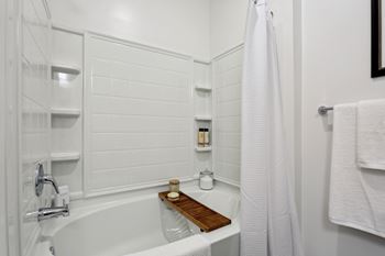 A white bathroom with a tub and a shower at Arcadia Cartersville Apartments, Cartersville, GA, 30121